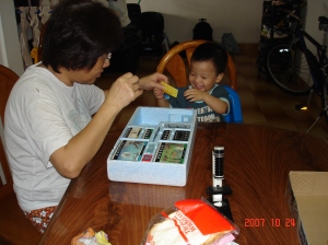 Ah Ma with Ian, handling microscopes
